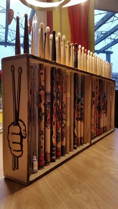 a display case filled with baseball bats on top of a wooden floor