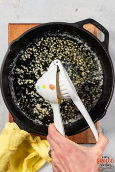 someone using a spatula to stir food in a skillet