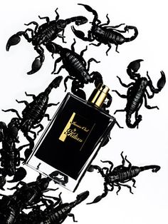 scorpions are scattered around a bottle of perfume