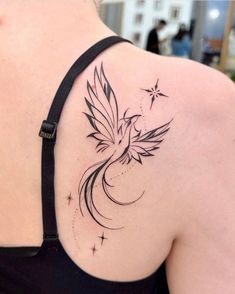 a woman's shoulder with a bird tattoo on it