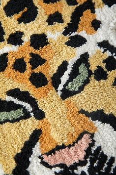 a close up of a rug with an animal design on the front and back side