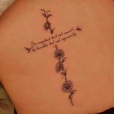 the back of a woman's stomach with flowers and a quote written on it