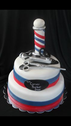 a cake decorated with barber's tools and scissors