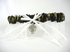 an image of a wedding garter with ribbon and seal on the front in camo print