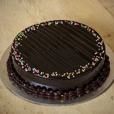 a chocolate cake with colorful sprinkles on it's top and bottom