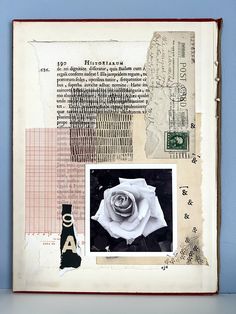 an old book with paper collages and pictures on the pages, including a rose