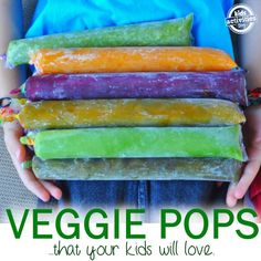 a person holding five pops in their hands with the words veggie pops that your kids will love