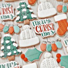 decorated christmas cookies on a table with merry lettering and stockings, hats, mittens