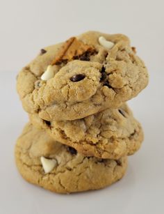 three cookies stacked on top of each other with chocolate chips and marshmallows