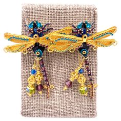 Indulge in the splendor of Lunch at the Ritz earrings, featuring striking damselflies with vibrant shades of purple, green, and blue. Adorned with dazzling rhinestones and intricate beading, these earrings are a luxurious addition to any collection. Elevate your style with these exclusive, hand-crafted pieces. Length: 2.5" Width: 2" Damselflies, Intricate Beading, The Ritz, Green And Blue, Shades Of Purple, Purple Green, Favorite Jewelry, Jewelry Earrings Dangle, Etsy Accessories