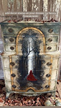 an old dresser with a painting on it