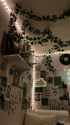 a living room filled with lots of lights and pictures on the wall next to a couch