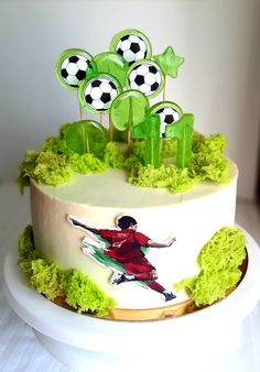 a cake decorated with grass and soccer decorations