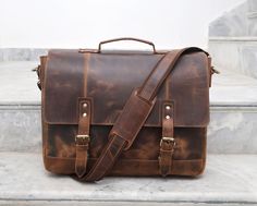 This 100% genuine buffalo leather travel bag is the perfect blend of style and functionality. The bag features a rustic, antique look and feel. Its classic design is timeless and offers plenty of room for your daily essentials. It is ideal for everyday use, travel, and even formal occasions. From the durable materials to the stylish design, this messenger bag is sure to become a staple in your wardrobe. The shoulder strap of this engraved bag comes with a shoulder pad for extra comfort. The stra Messenger Bag For Men, Mens Satchel, Laptop Handbag, Wedding Gifts For Groomsmen, Groomsmen Wedding, Leather Travel Bag, Handbag For Women, Messenger Bag Men, Buffalo Leather