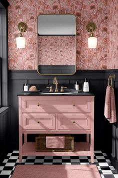 a bathroom with black and pink walls, checkered flooring and gold fixtures on the vanity