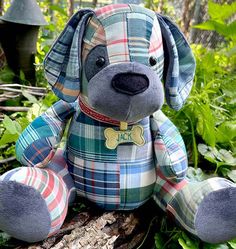 a stuffed dog sitting on top of a tree stump in the woods with greenery