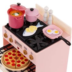 a pink toy stove with food on it