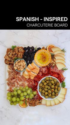 an assortment of different types of food on a platter with the words spanish - inspired charcuterie board