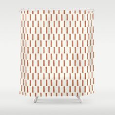 a shower curtain with an orange and white pattern