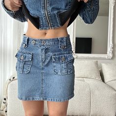 90s vintage denim mini skirt with cargo pocket details - 28 inch waist - Model is 32D/26 waist/5ft Fitted Vintage Mini Denim Skirt, Y2k Denim Blue Mini Skirt With Pockets, Cargo Mini Skirt Denim, Y2k Western, Y2k Denim Mini Cargo Skirt, Vintage Cotton Denim Mini Skirt, Skirt Cargo, Mini Rock, Skirt Y2k