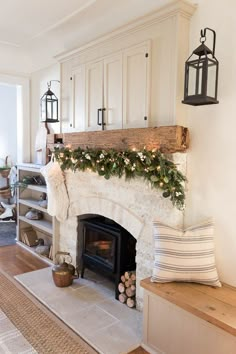 a living room filled with furniture and a fire place covered in greenery next to a fireplace