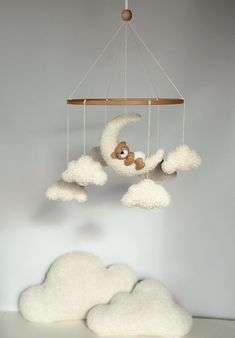 there is a stuffed animal on the cloud mobile