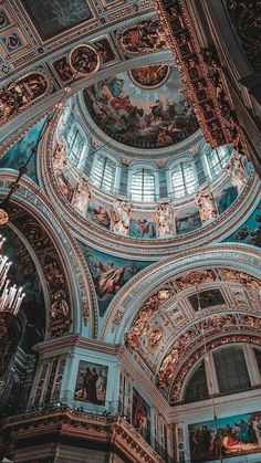 looking up at the ceiling in an ornately decorated building with many paintings on it