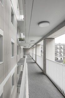 an empty hallway with windows and balconies