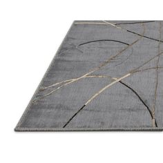 a gray rug with gold lines on the top and bottom, in front of a white background