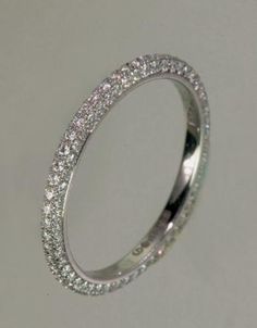 a white gold wedding band with rows of diamonds