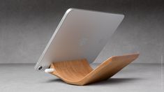 the wooden stand is holding an ipad