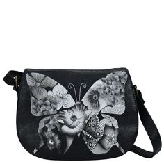 a black butterfly purse with flowers on it