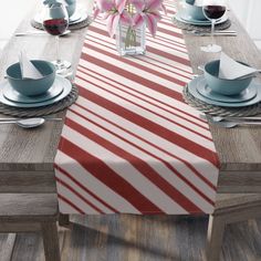 the table is set with red and white striped linens