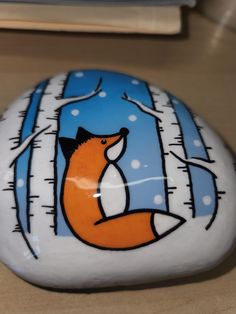 a painted rock with a fox on it