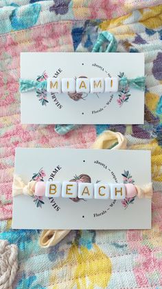 two bracelets that say mama and the word beach written in small letters on them