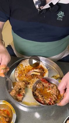 a man is preparing food on a silver platter with utensils in front of him