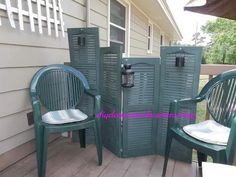 three green chairs sitting next to each other on a porch