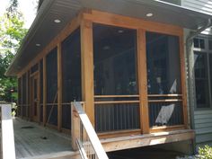 a screened porch with stairs leading up to it