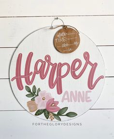 a wooden sign that says harper anne with pink flowers and leaves on the front