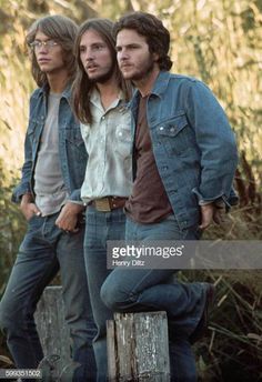 three young men standing next to each other