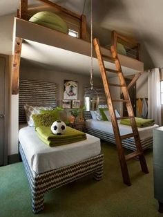 a bedroom with bunk beds and a ladder to the top level above it is a green carpeted floor