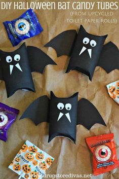 halloween bat candy tubes made out of toilet paper rolls with eyes and bats on them