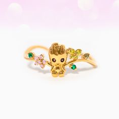 Behold, everyone's favorite little flora colossus - Marvel's Guardians of the Galaxy Groot, now available as a charming ring! Our Marvel's I Am Groot Ring features an adorable baby Groot surrounded by sprouting flowers and leaves. With intricate details and sparkling gems, it's sure to become you're go to ring. Groot Ring, Gifts For Marvel Fans, Colossus Marvel, Disney Princess Tangled, Panther Earrings, Disney Princess Sleeping Beauty, Black Panther Necklace, Avengers Icon, Princess Tangled