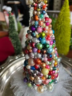 a small christmas tree made out of ornaments