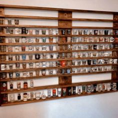 a wooden shelf filled with lots of cups