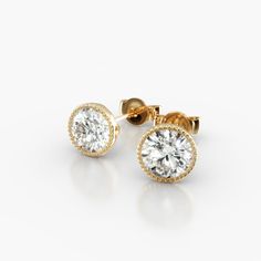 18K Yellow Gold Milgrain Bezel Diamond Stud Earrings (Mounting). This design is the perfect mix of modern and vintage design, crafted to accent the beauty of the round brilliant diamond of your choice with a milgrain bezel and rolled wire basket. This earring will fit slightly off the ear and features friction backs. Luxury Formal Earrings With Single Cut Diamonds, Timeless Formal Earrings With Single Cut Diamonds, Timeless Round Diamond Earrings For Formal Occasions, Luxury Yellow Gold Earrings With Prong Setting, Refined 14k Gold Round Earrings, Classic Round Halo Design Earrings, Classic Round Halo Earrings, Elegant Round Everyday Luxury Earrings, Elegant Everyday Luxury Round Earrings