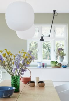 a table with bowls and vases on it