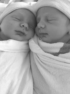 two newborn babies are wrapped in blankets