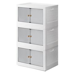 three white plastic storage containers stacked on top of each other with gold handles and doors