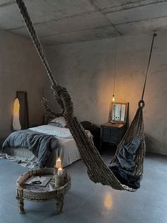 a bedroom with a bed and a hammock hanging from the ceiling in it